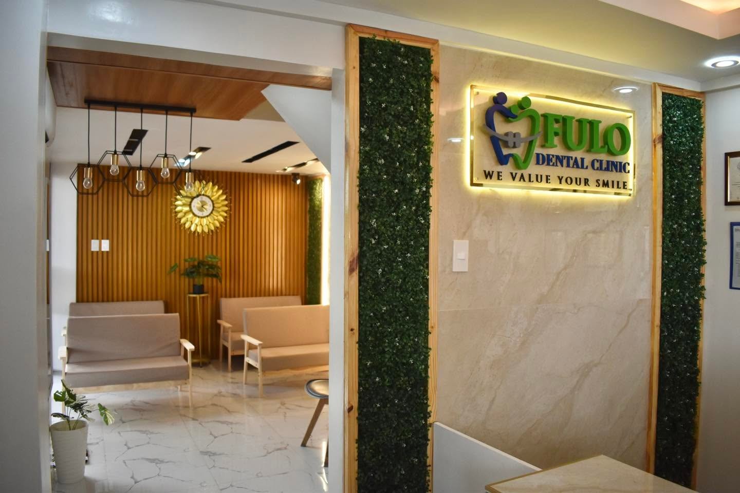 Reception with the lit Fulo Dental Clinic sign and the waiting area